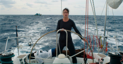 woman steering a boat on rough seas styx movie scene