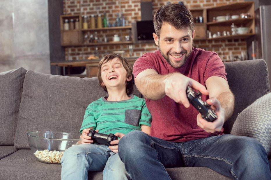 dad playing video games with son