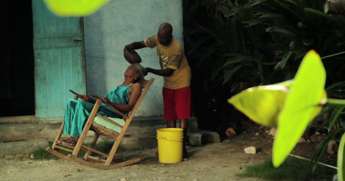 haitian man washing womans hair