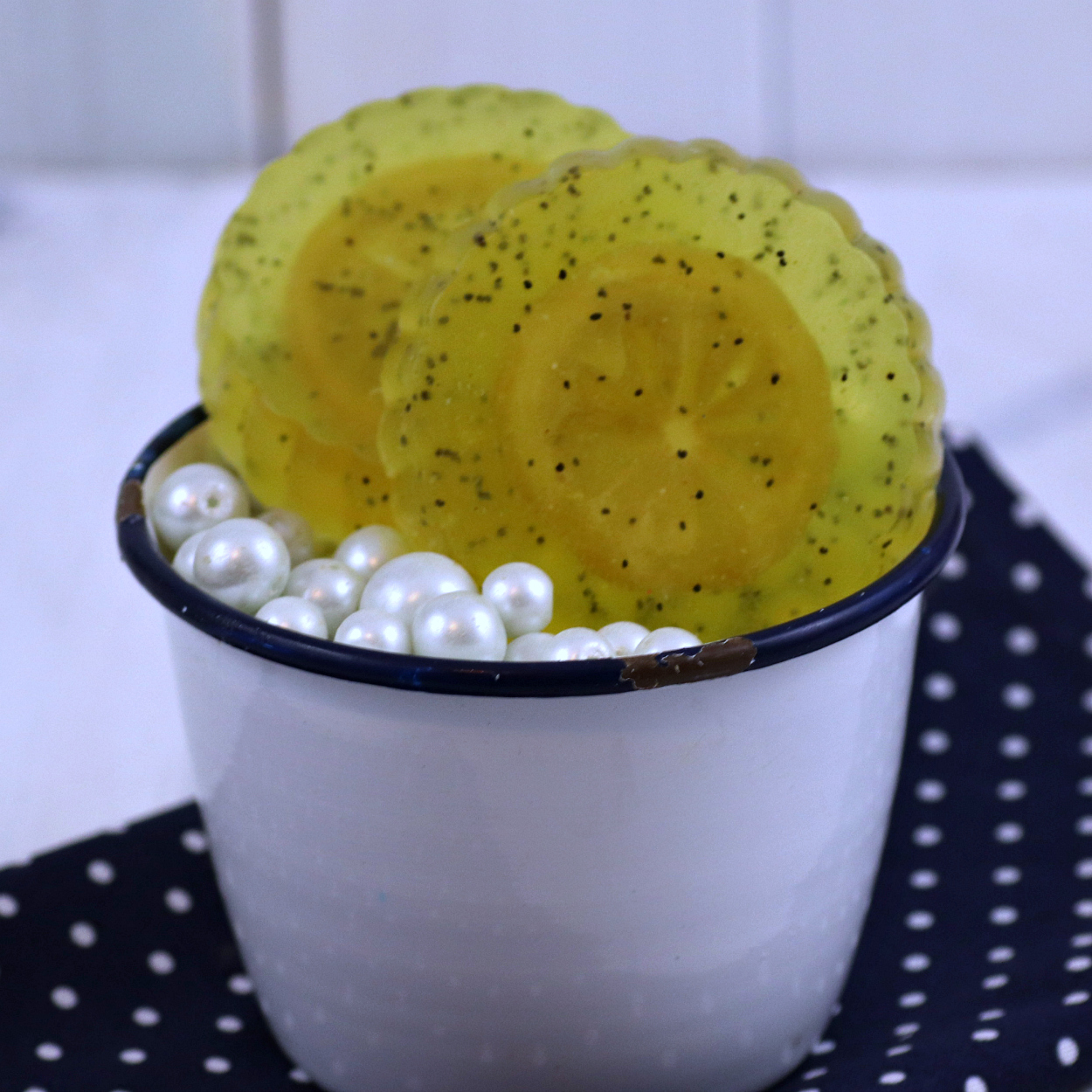 lemon poppyseed soap in white soap dish