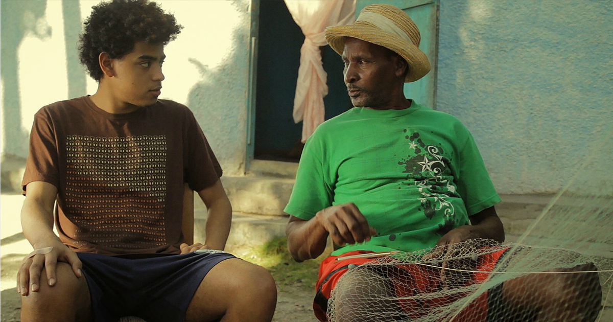 young man listening to older man in haiti
