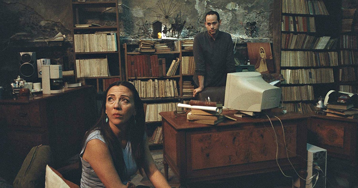 woman and man in office with old books on shelves