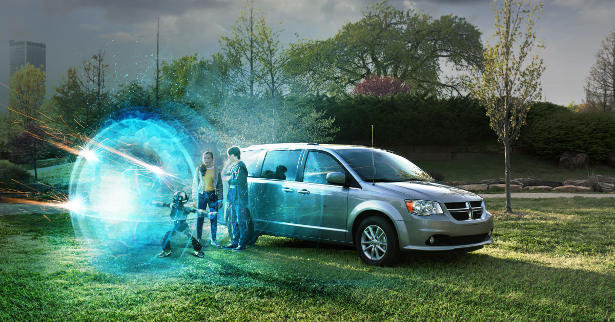 ari robot and kids next to minivan