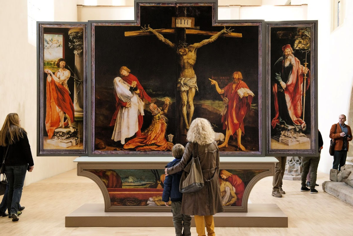 woman and boy looking at religious art