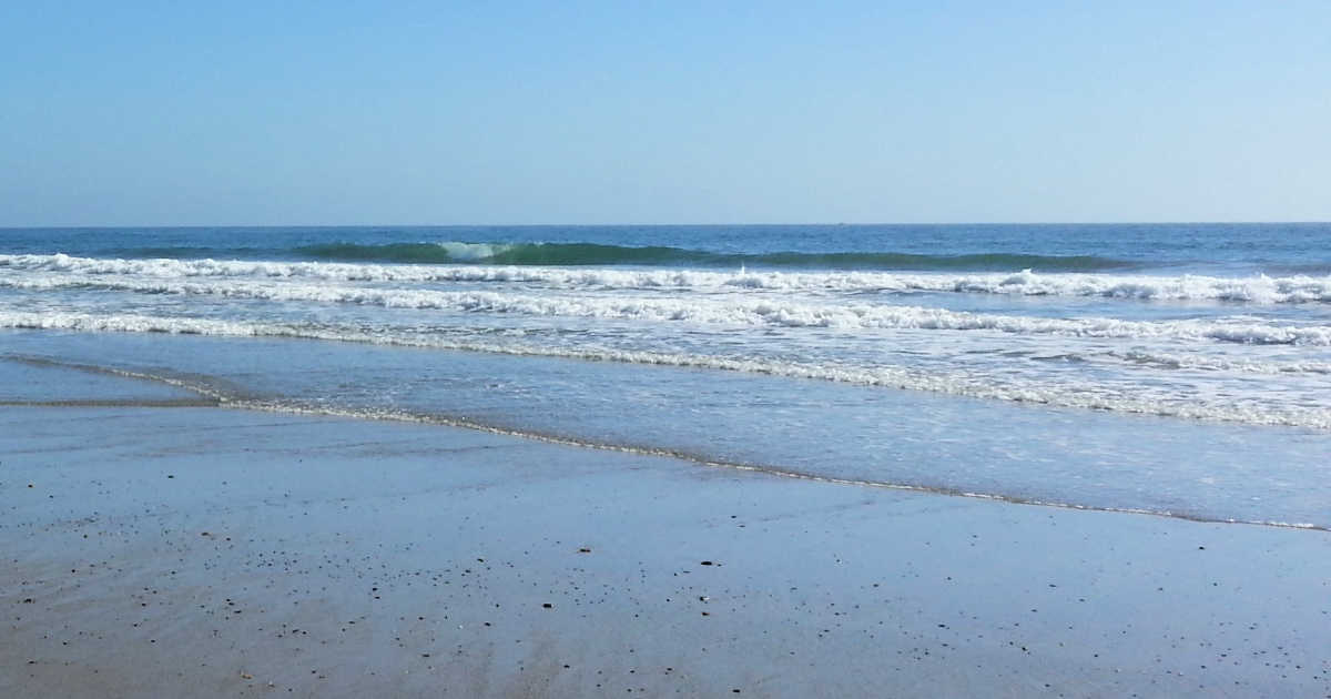 small waves rolling onto the shore