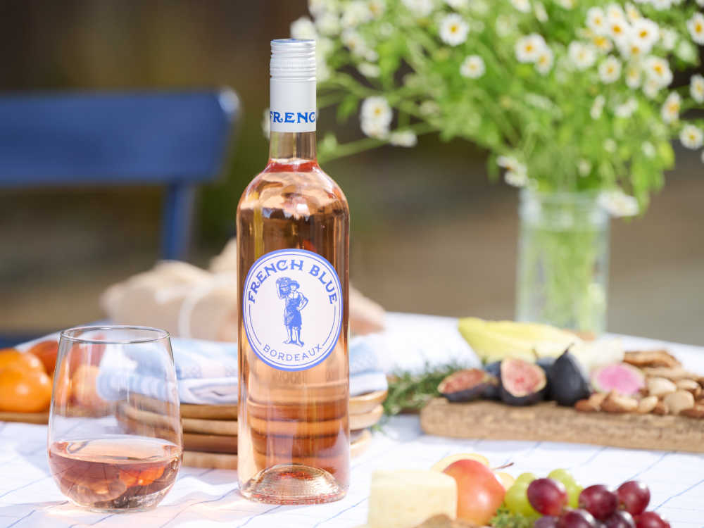 picnic spread with bottle of french blue bordeaux rose. 