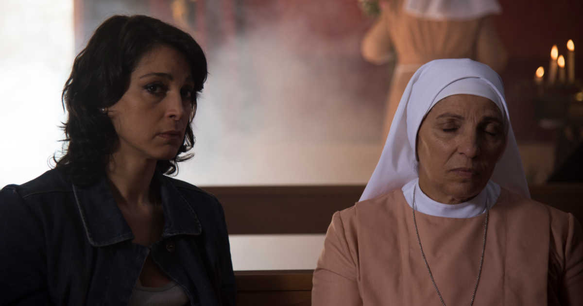 woman sitting with nun in italian church.