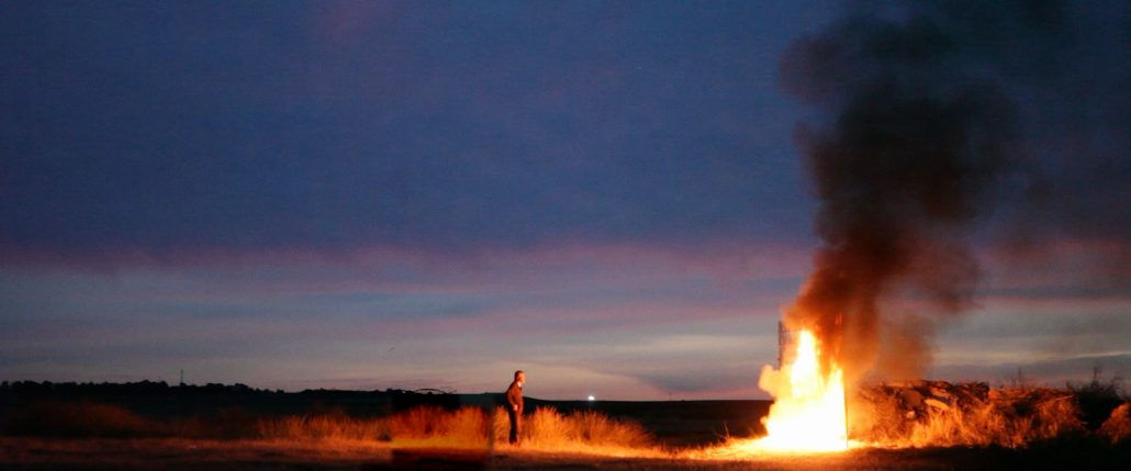 man watching fire burn