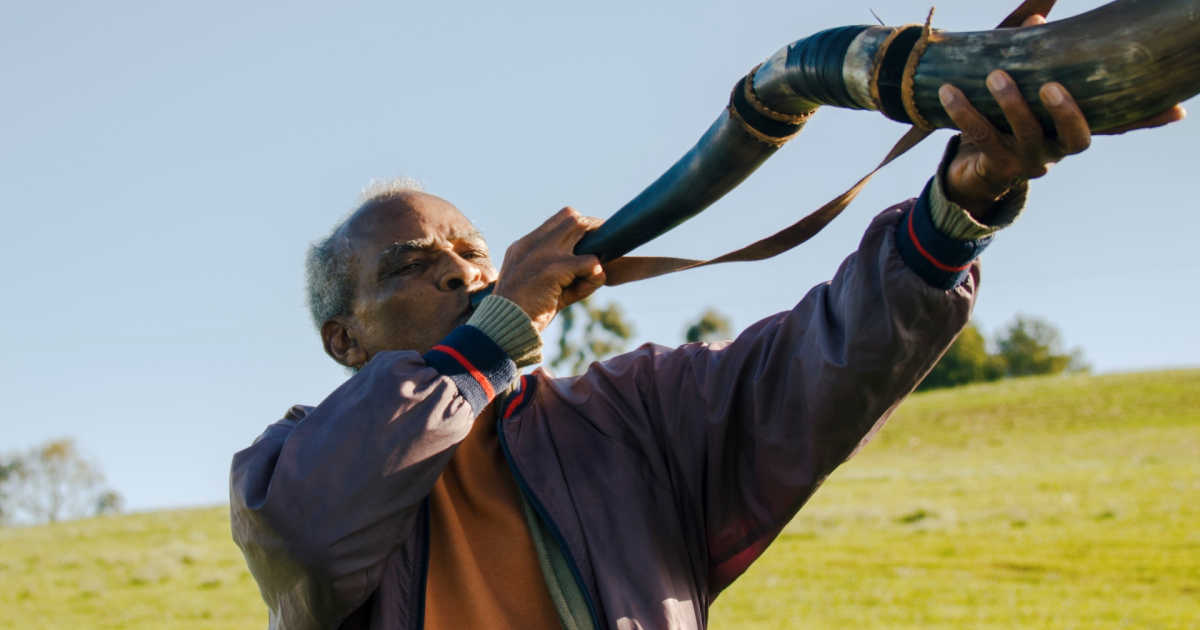 brazilian man playing horn