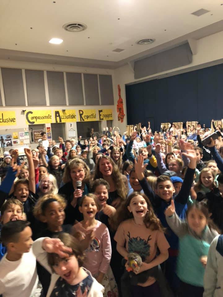 Explorer Gemina Garland-Lewis and Trudi snap a selfie with students at West Woodland Elementary in Seattle. Can you find them?