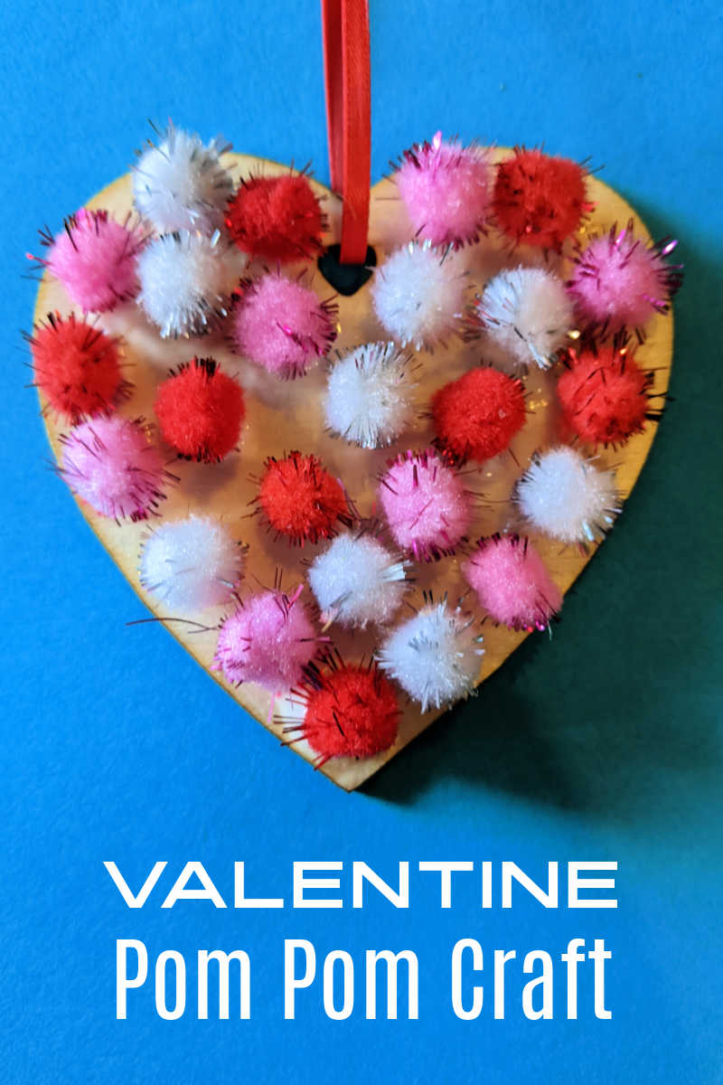 Kids and adults can make a Valentine pom pom craft heart to give to someone special or to use as a holiday decoration. 