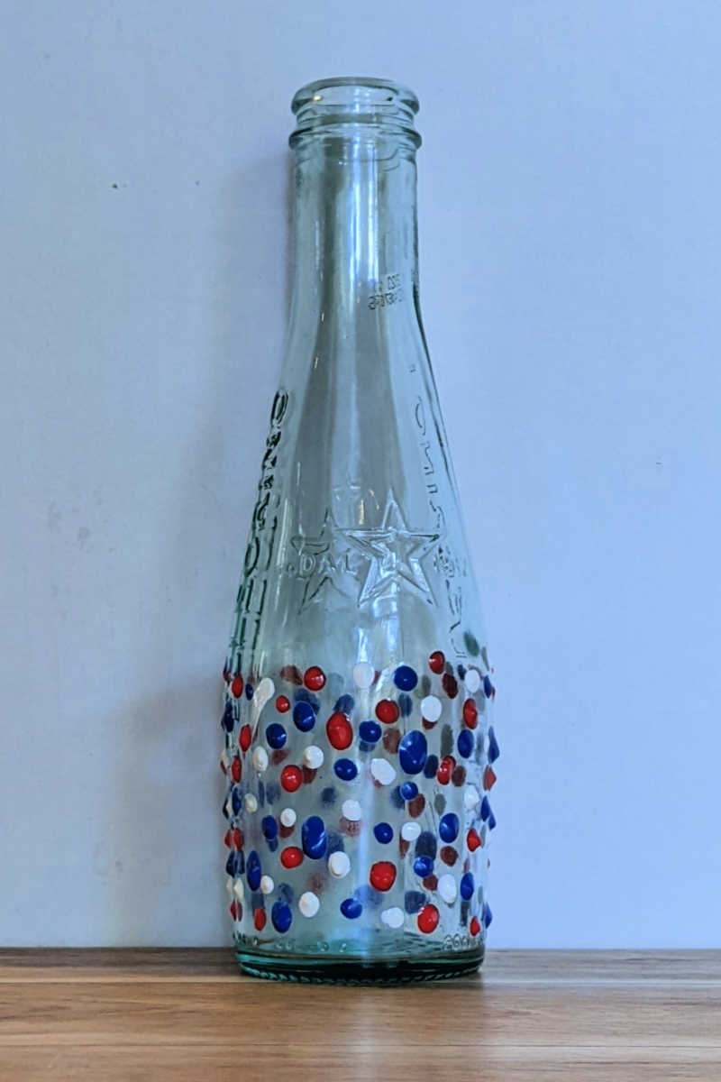 This easy patriotic bottle craft is perfect for the 4th of July! With just a few supplies, you can create a beautiful and festive decoration.