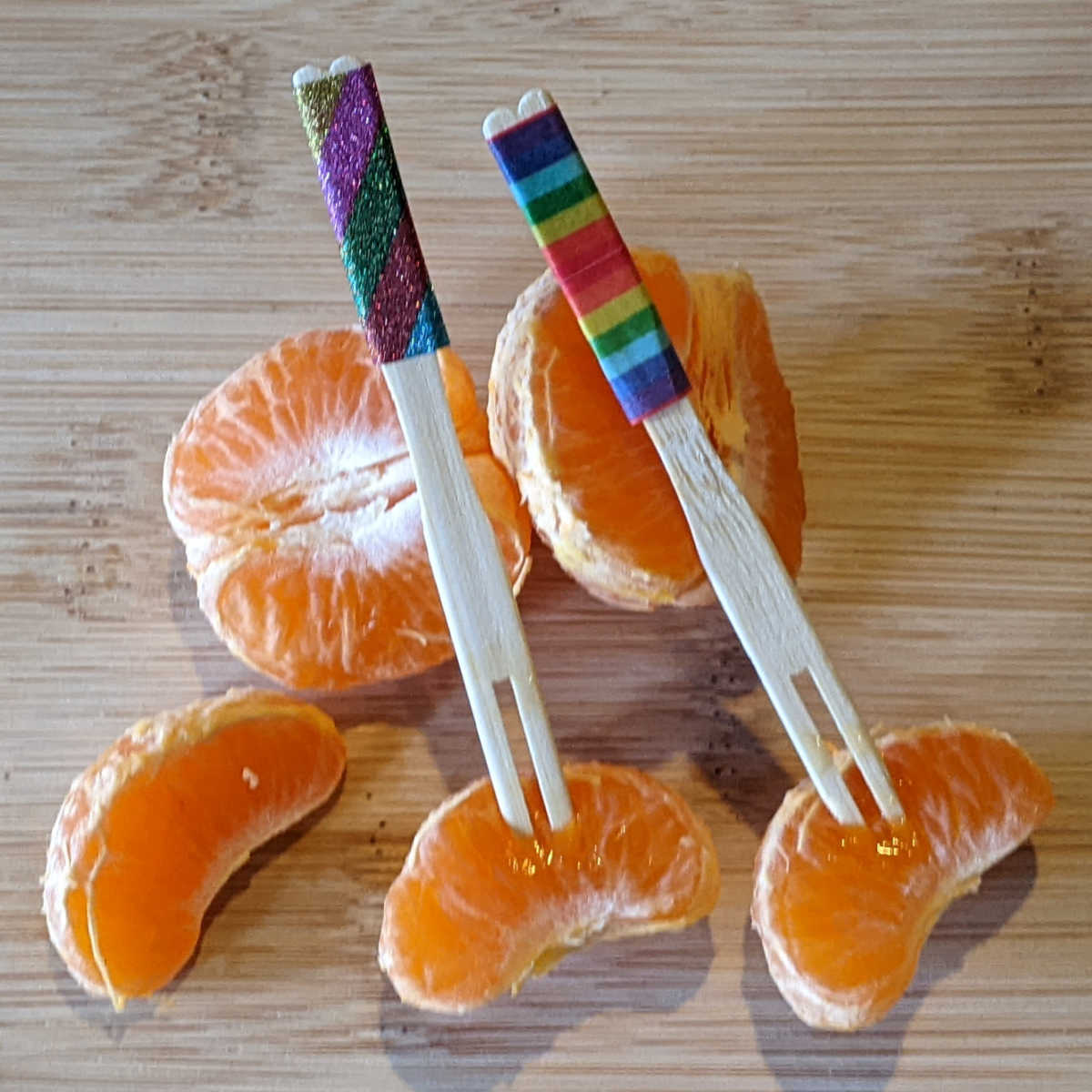tangerines with rainbow party forks