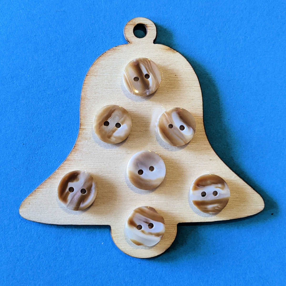 making a wood bell craft with buttons