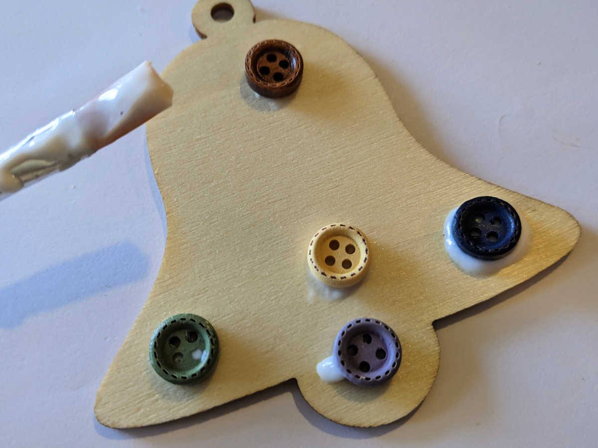 gluing buttons on the bell