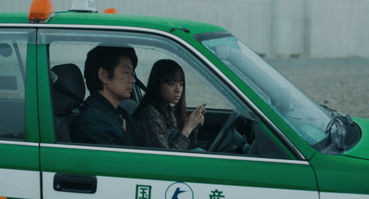 woman and man in japan police car