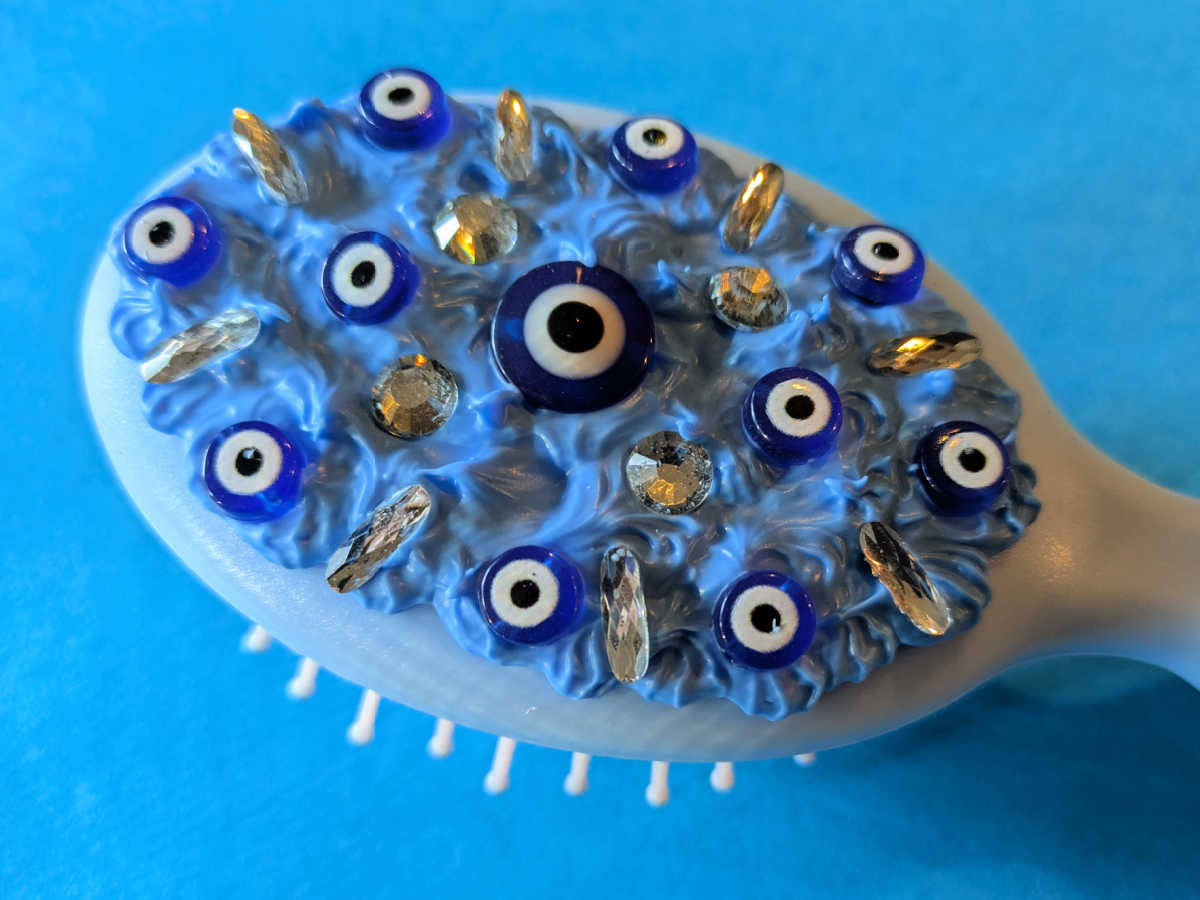 close up evil eye hair brush