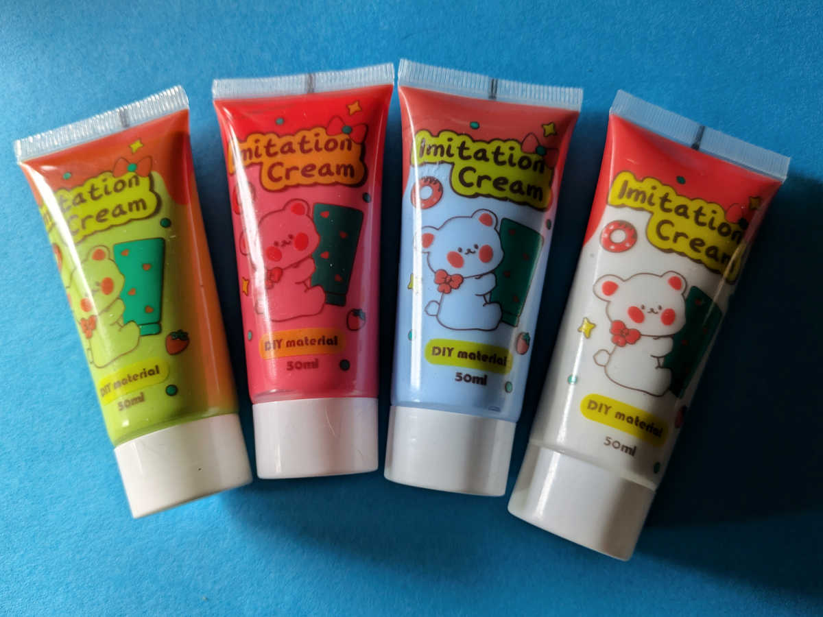 four whipped cream glue tubes