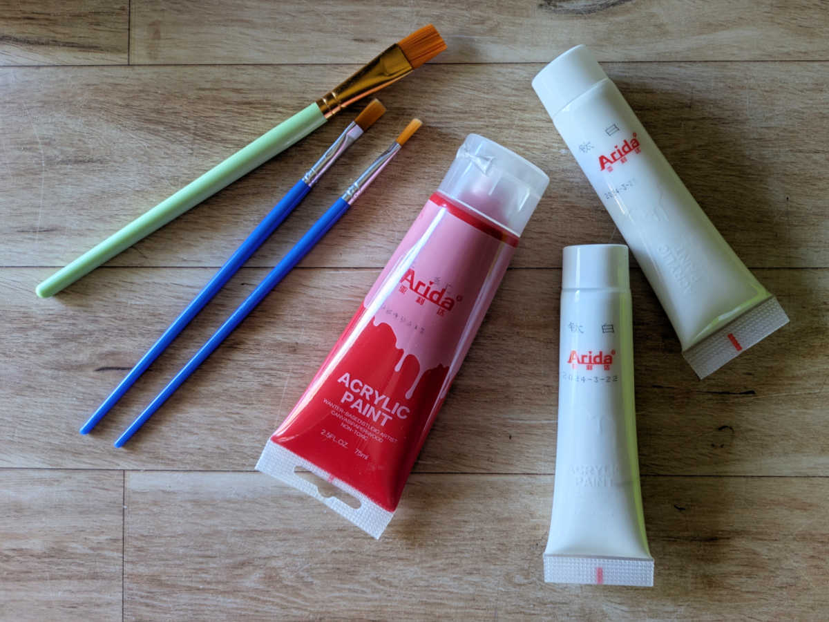 paint brushes red and white acrylic paint