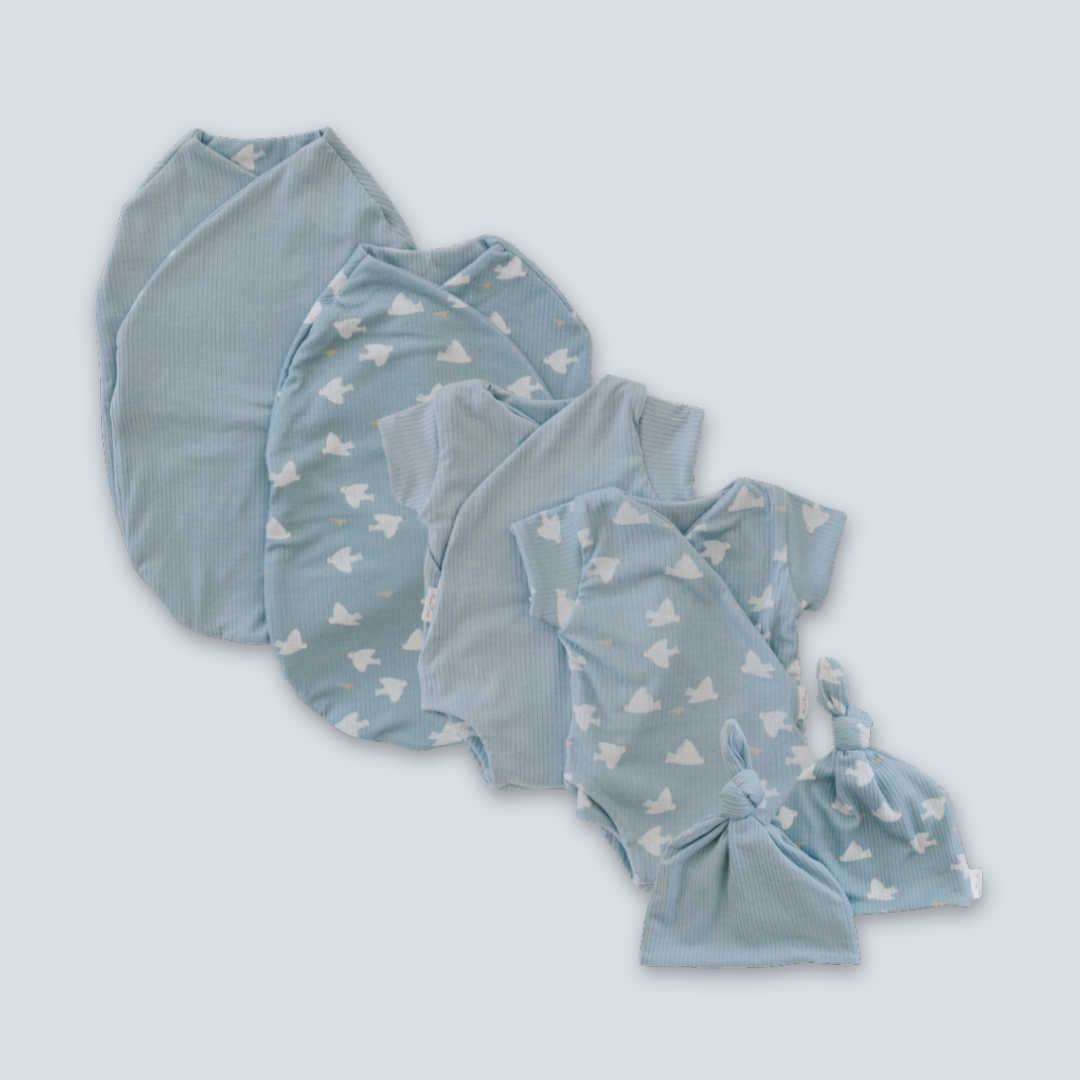The Mama Coco Newborn Baby Essentials Bundle is an excellent gift! This set includes a bodysuit, beanie and an easy to use cocoon swaddle. It’s reversible, fastener-free and is even available in preemie sizes!