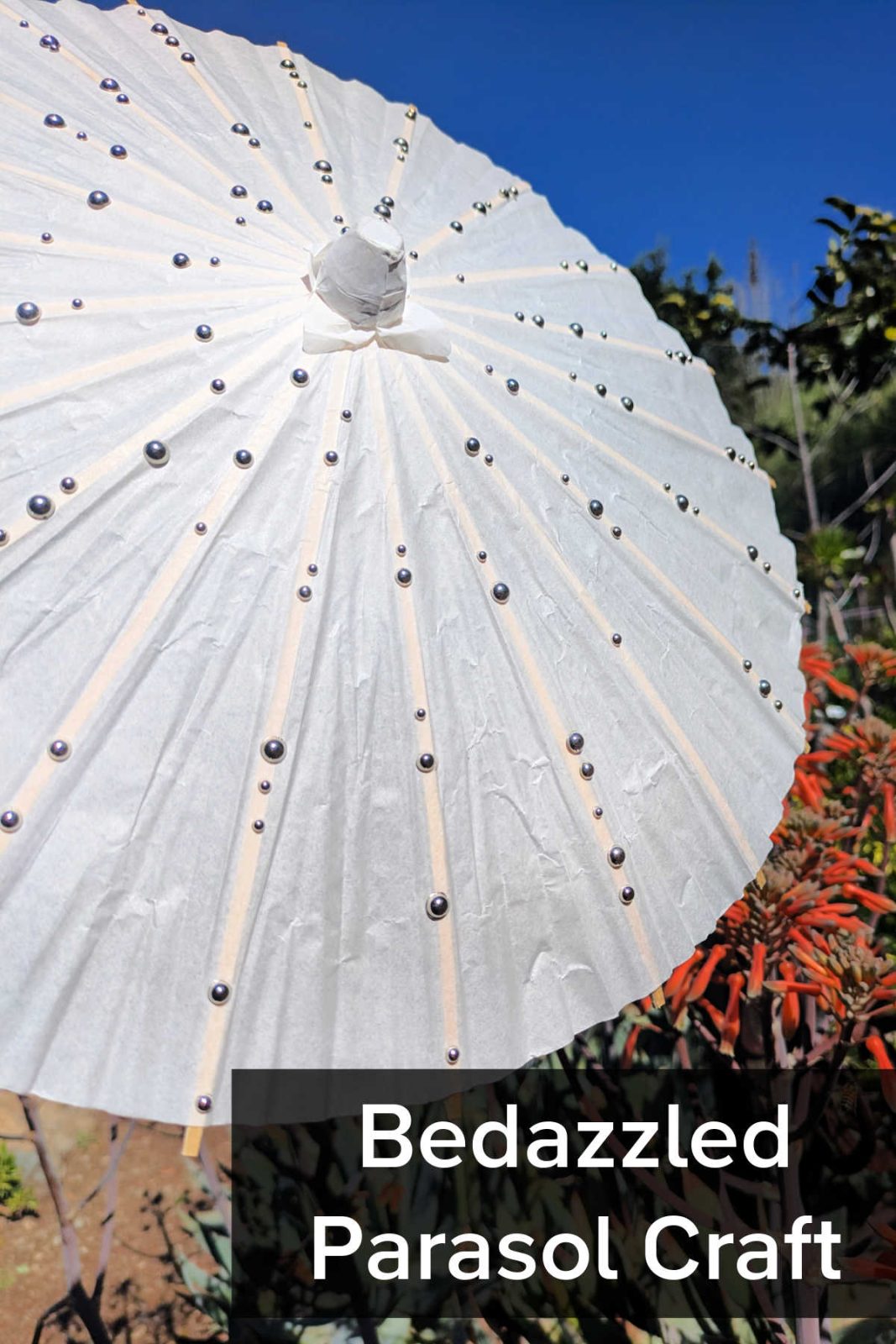 Looking for a simple and sparkling activity? This DIY bedazzled parasol craft is perfect for toddlers and big kids alike using paper umbrellas and gem stickers!