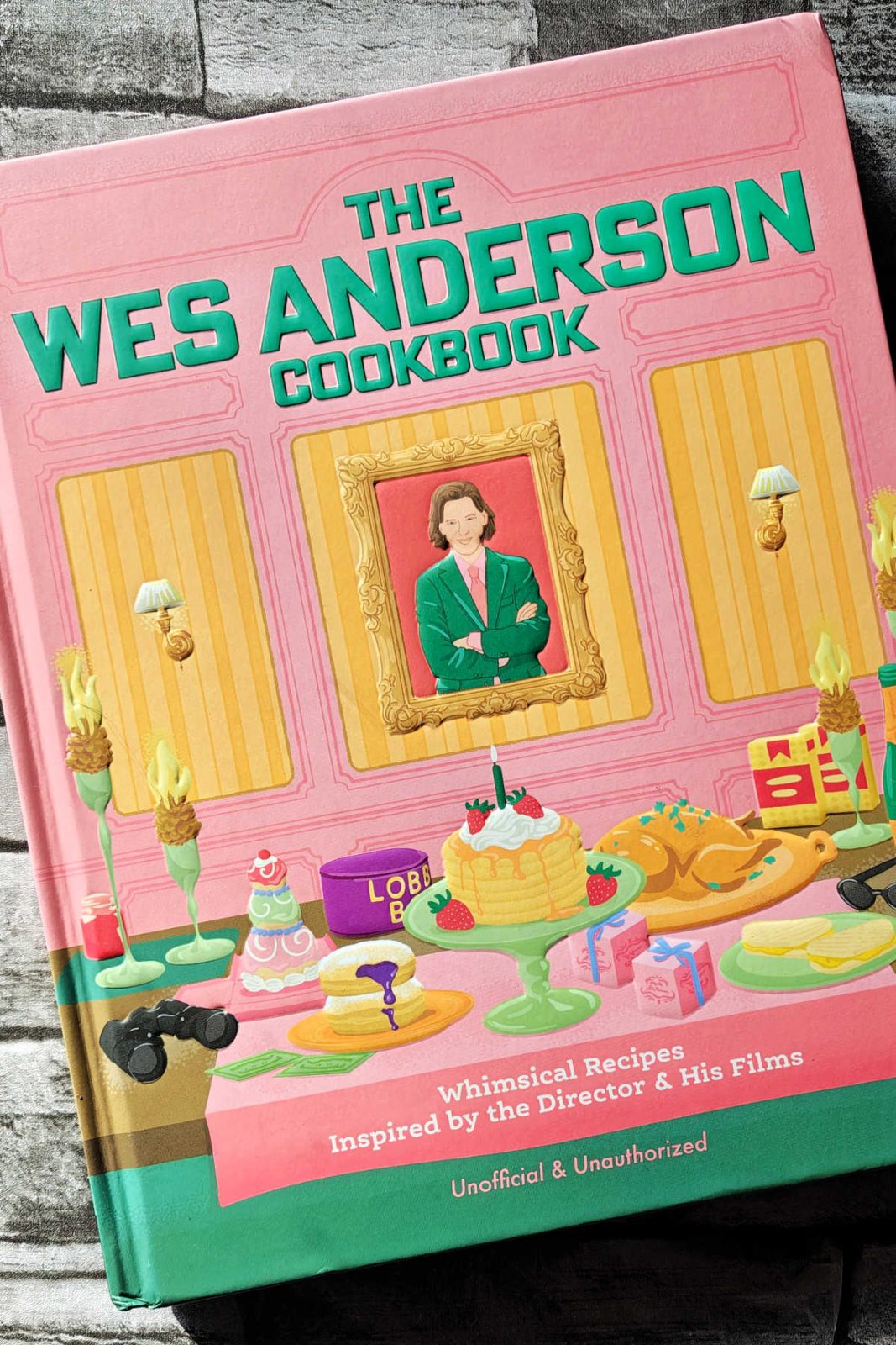 Step into the whimsical world of The Wes Anderson Cookbook! 🏨 The book by Michelle Anderson and Chris Peterson offers 55+ recipes inspired by his iconic films. It's a good gift for film buffs and foodies looking to create a movie night feast. 🥧