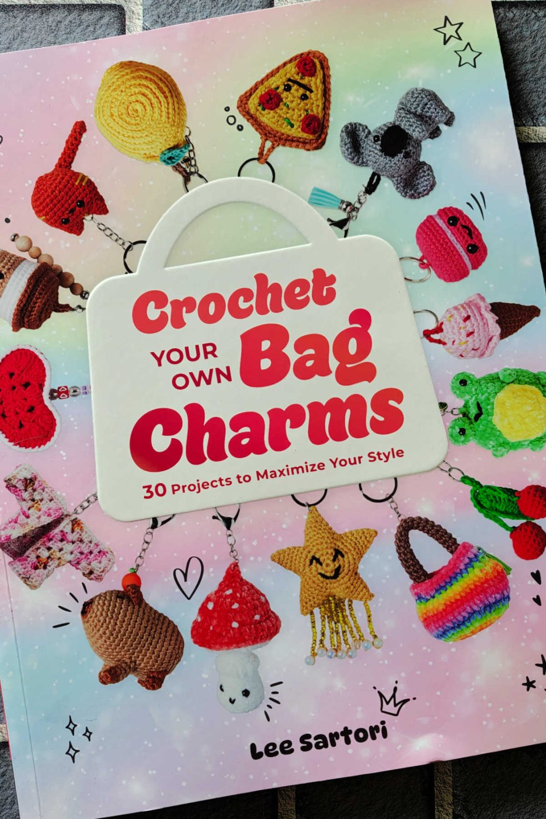 This review of Crochet Your Own Bag Charms explores a fun pattern book filled with 30 quick, trendy designs. Discover how these hour-or-less projects can help you clear out your yarn scrap stash and make cute handmade gifts.